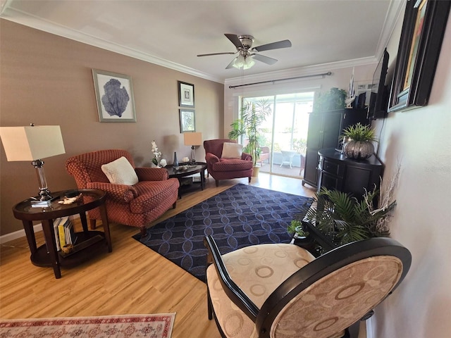 living room featuring a ceiling fan, crown molding, and wood finished floors