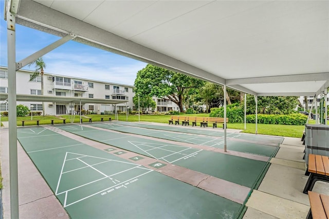 view of home's community featuring a lawn and shuffleboard