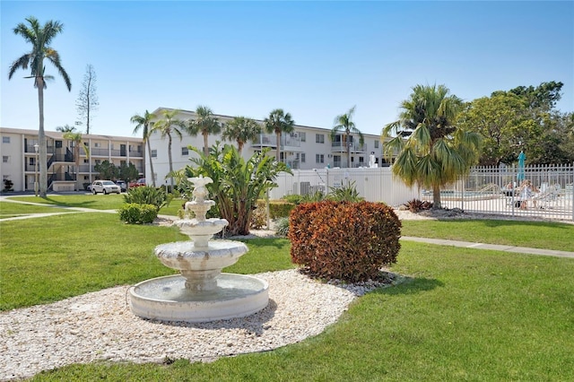 surrounding community with a yard, a residential view, and fence