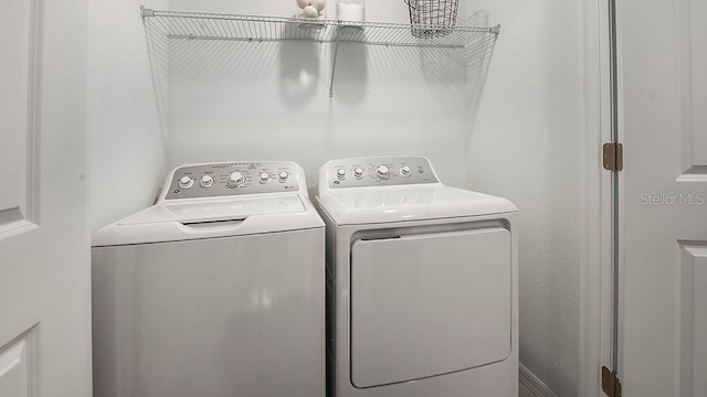 laundry area featuring washing machine and clothes dryer and laundry area