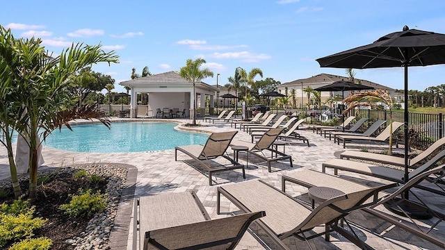 community pool featuring a patio area and fence