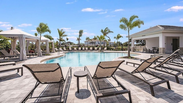 pool with a gazebo, a patio area, and fence