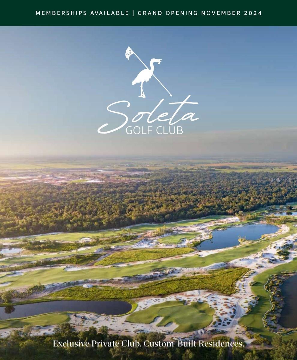 aerial view of property and surrounding area with a nearby body of water and a golf club