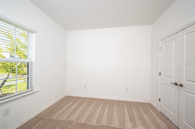 10171 Milky Way Cir, Sarasota, FL 34241 - empty room with light colored carpet, a wealth of natural light, and baseboards