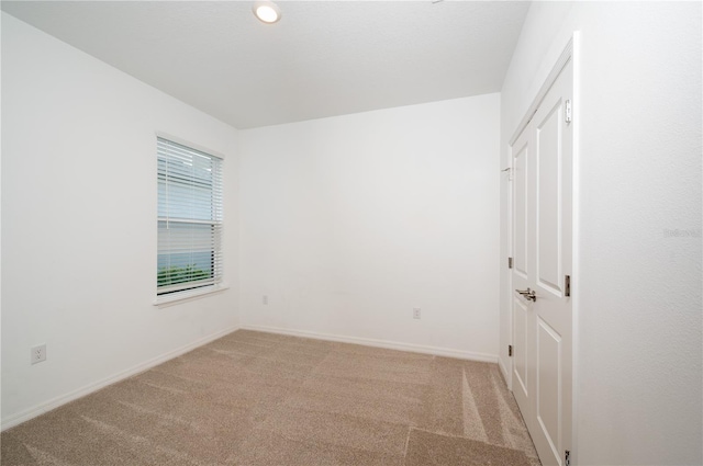 10171 Milky Way Cir, Sarasota, FL 34241 - spare room featuring baseboards and light carpet