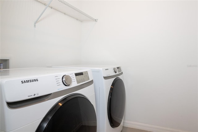 10171 Milky Way Cir, Sarasota, FL 34241 - laundry room featuring baseboards, washing machine and dryer, and laundry area