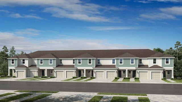view of front of property featuring driveway, a residential view, and a garage