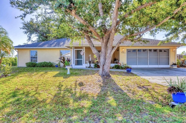 9366 Westminster Ave, Englewood, FL 34224 - single story home featuring concrete driveway, stucco siding, an attached garage, and a front yard
