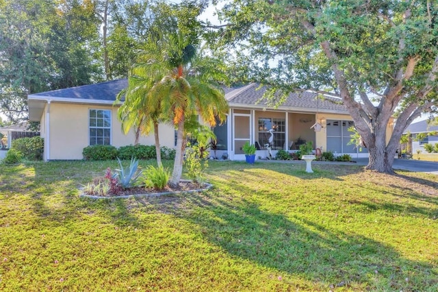 9366 Westminster Ave, Englewood, FL 34224 - single story home with a front yard, stucco siding, and a sunroom