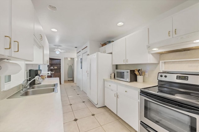 9366 Westminster Ave, Englewood, FL 34224 - kitchen featuring white appliances, under cabinet range hood, white cabinetry, light countertops, and light tile patterned flooring