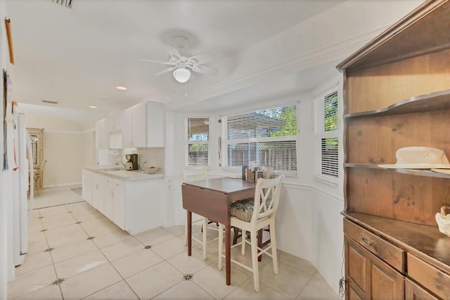 9366 Westminster Ave, Englewood, FL 34224 - dining space with ceiling fan, light tile patterned floors, ornamental molding, and recessed lighting