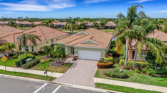 212 River Enclave Ct, Bradenton, FL 34212 - mediterranean / spanish house featuring a tiled roof, a residential view, an attached garage, and stucco siding