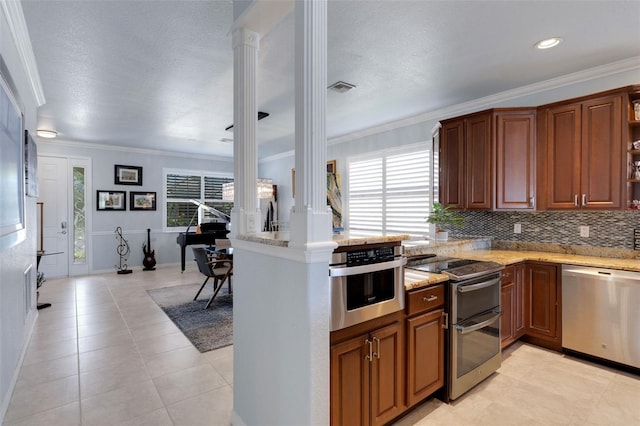 212 River Enclave Ct, Bradenton, FL 34212 - kitchen featuring stainless steel appliances, decorative columns, light stone counters, tasteful backsplash, and crown molding