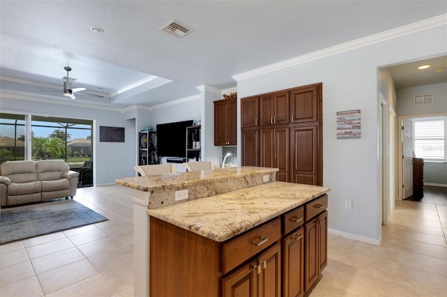 212 River Enclave Ct, Bradenton, FL 34212 - kitchen featuring a center island, light tile patterned floors, ornamental molding, open floor plan, and a ceiling fan