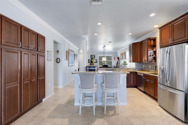 212 River Enclave Ct, Bradenton, FL 34212 - kitchen featuring stainless steel appliances, crown molding, open shelves, a kitchen bar, and recessed lighting
