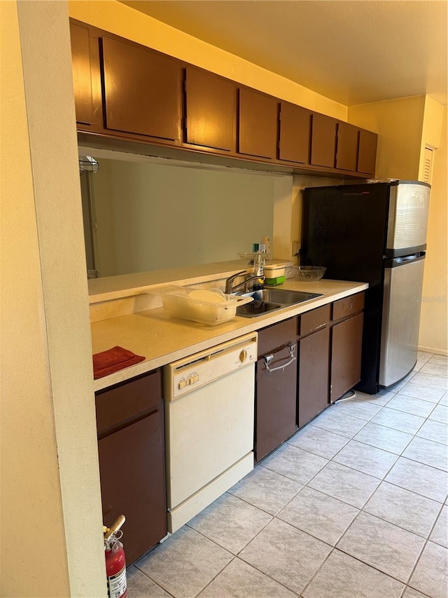 5014 Barrington Cir Unit 2102, Sarasota, FL 34234 - kitchen featuring white dishwasher, a sink, light countertops, and light tile patterned flooring