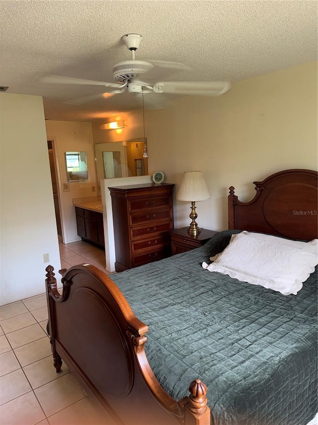 5014 Barrington Cir Unit 2102, Sarasota, FL 34234 - bedroom with a textured ceiling, light tile patterned floors, and ceiling fan
