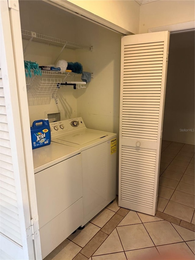 5014 Barrington Cir Unit 2102, Sarasota, FL 34234 - washroom with washer and dryer and light tile patterned floors