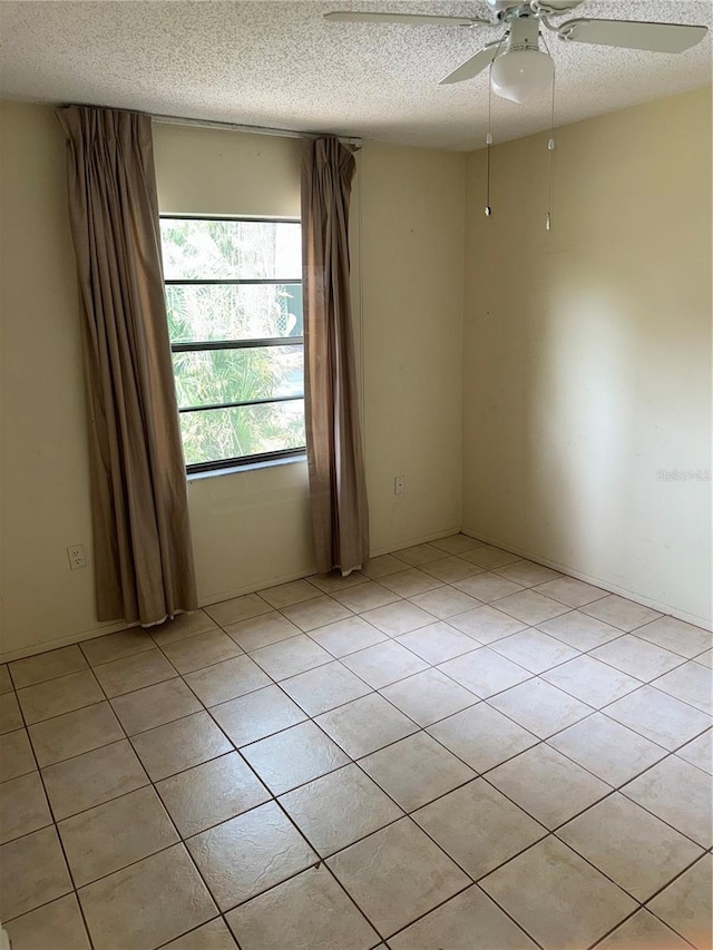 5014 Barrington Cir Unit 2102, Sarasota, FL 34234 - unfurnished room featuring ceiling fan, a textured ceiling, and light tile patterned floors
