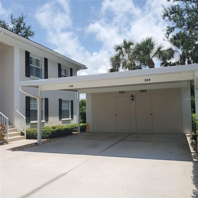802 Montrose Dr Unit 204, Venice, FL 34293 - view of front of house with stucco siding and a carport