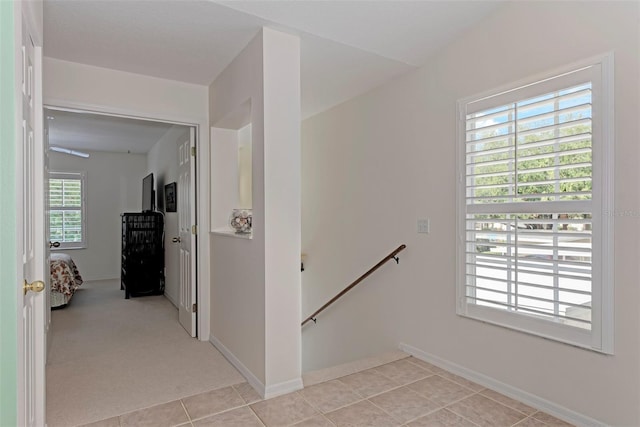 802 Montrose Dr Unit 204, Venice, FL 34293 - corridor with an upstairs landing, light tile patterned floors, and baseboards