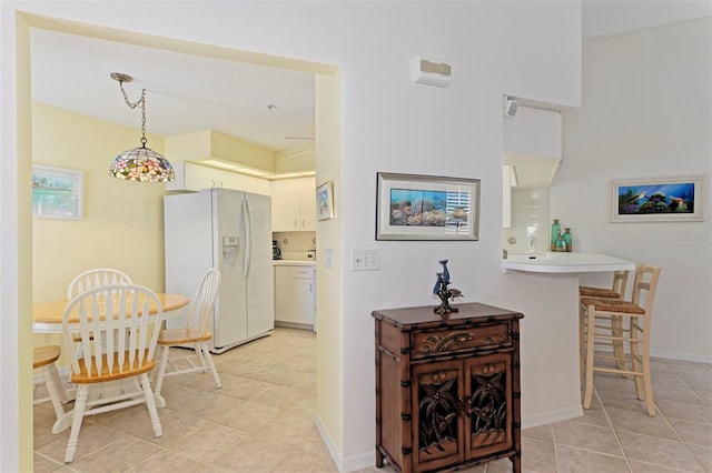 802 Montrose Dr Unit 204, Venice, FL 34293 - dining space featuring light tile patterned flooring and baseboards