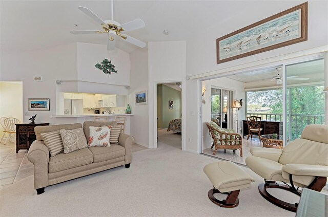 802 Montrose Dr Unit 204, Venice, FL 34293 - living room featuring ceiling fan, high vaulted ceiling, baseboards, and light colored carpet