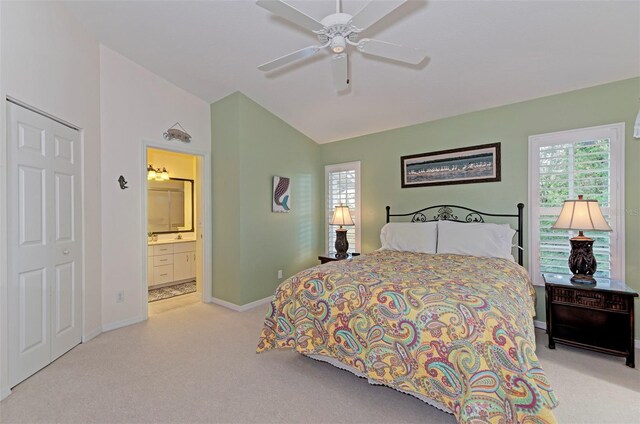 802 Montrose Dr Unit 204, Venice, FL 34293 - carpeted bedroom featuring vaulted ceiling, baseboards, multiple windows, ensuite bath, and ceiling fan