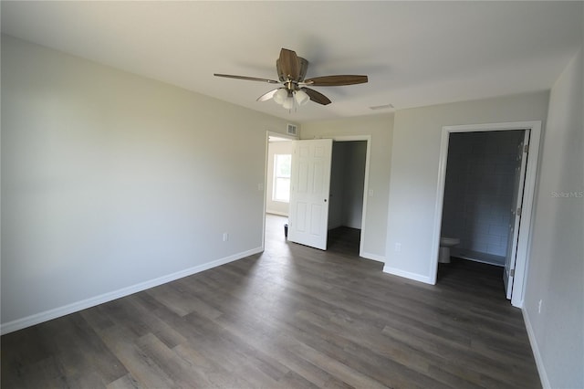 1208 SE Mills Ave, Arcadia, FL 34266 - unfurnished bedroom featuring dark wood-type flooring, baseboards, connected bathroom, and a ceiling fan