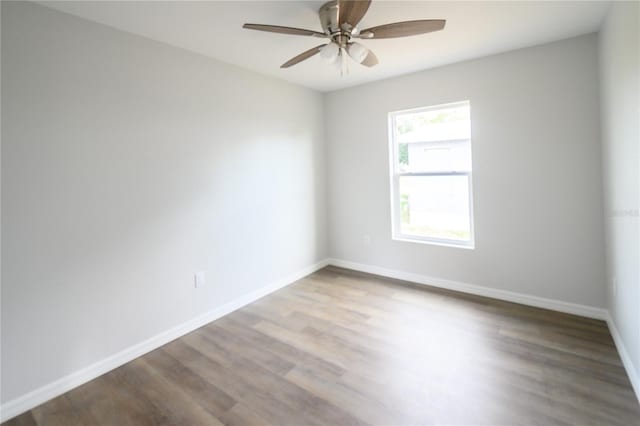 1208 SE Mills Ave, Arcadia, FL 34266 - spare room featuring ceiling fan, wood finished floors, and baseboards