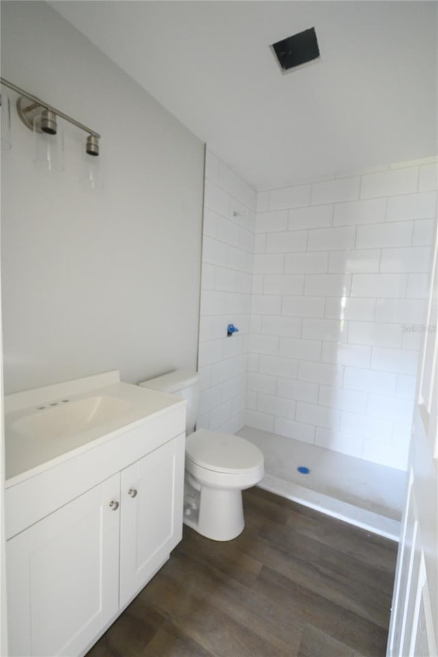 1208 SE Mills Ave, Arcadia, FL 34266 - full bathroom with a stall shower, toilet, wood finished floors, and vanity