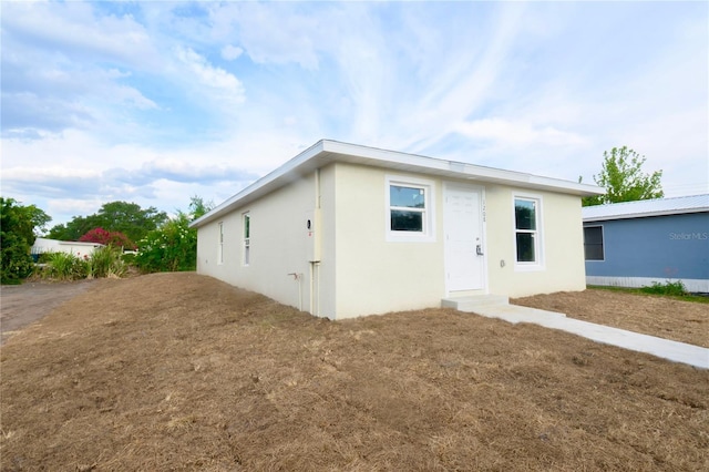 1208 SE Mills Ave, Arcadia, FL 34266 - back of house featuring stucco siding