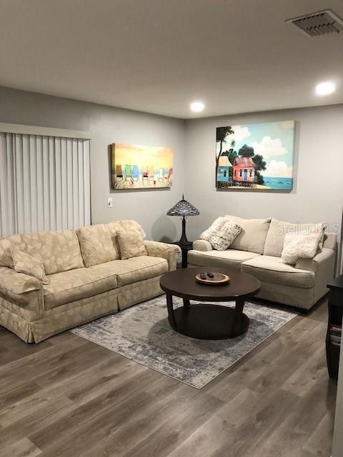 2726 Knoll St E, Palm Harbor, FL 34683 - living area featuring wood finished floors and recessed lighting
