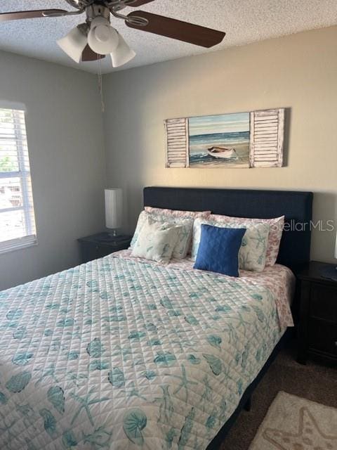 2726 Knoll St E, Palm Harbor, FL 34683 - carpeted bedroom with a textured ceiling and a ceiling fan
