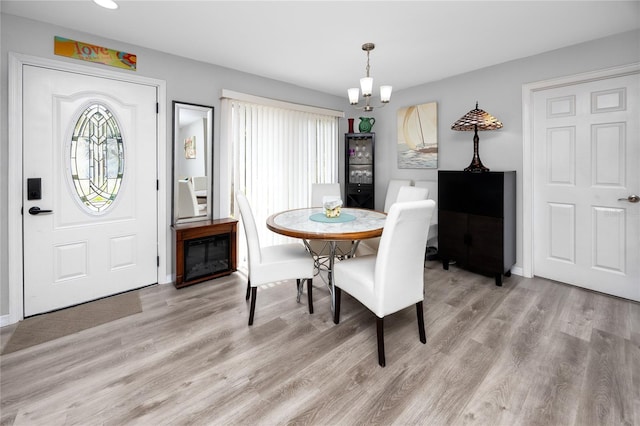 2726 Knoll St E, Palm Harbor, FL 34683 - dining space with a chandelier, light wood-style floors, and recessed lighting