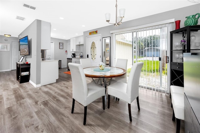 2726 Knoll St E, Palm Harbor, FL 34683 - dining room with a chandelier, light wood-style floors, and recessed lighting