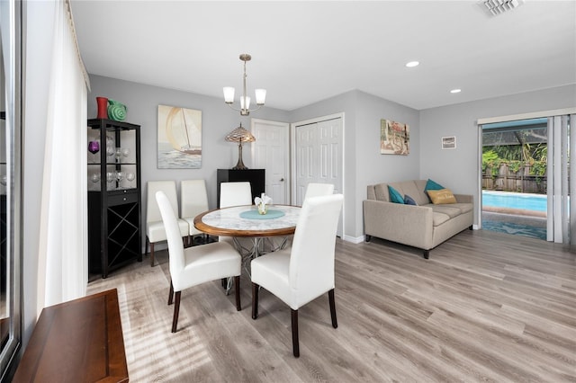 2726 Knoll St E, Palm Harbor, FL 34683 - dining area with light wood-style flooring, recessed lighting, and a chandelier