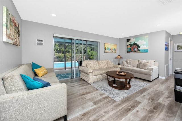 2726 Knoll St E, Palm Harbor, FL 34683 - living area with light wood finished floors and recessed lighting
