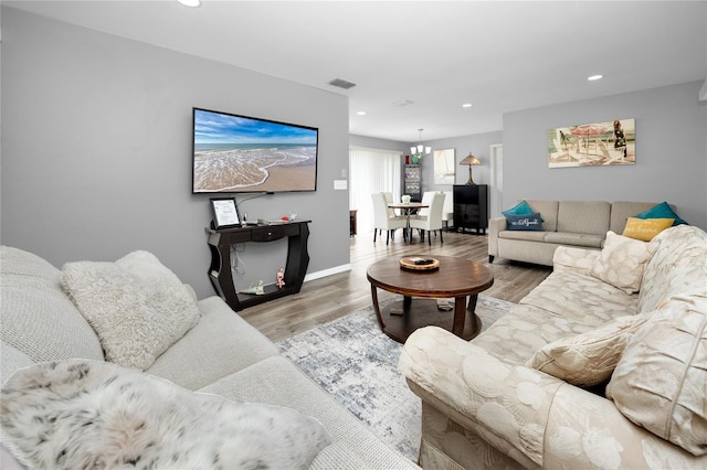 2726 Knoll St E, Palm Harbor, FL 34683 - living room featuring recessed lighting, light wood-style floors, and a chandelier