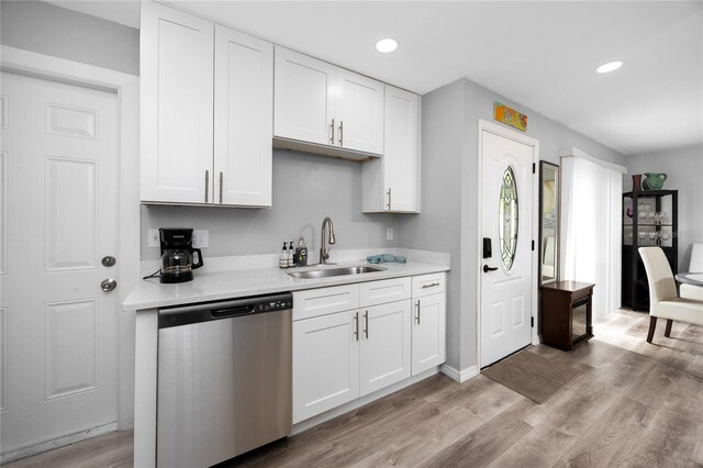 2726 Knoll St E, Palm Harbor, FL 34683 - kitchen featuring dishwasher, light countertops, white cabinets, light wood-style floors, and recessed lighting