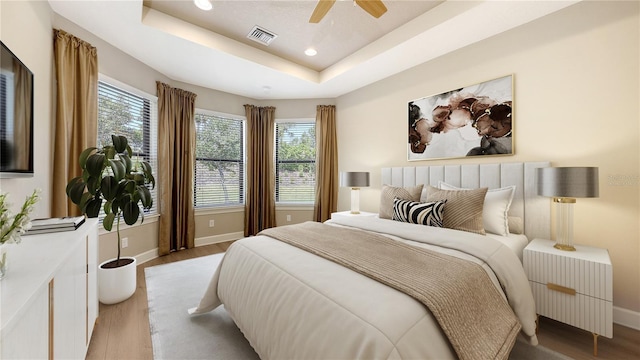 bedroom featuring multiple windows, light wood finished floors, baseboards, and recessed lighting