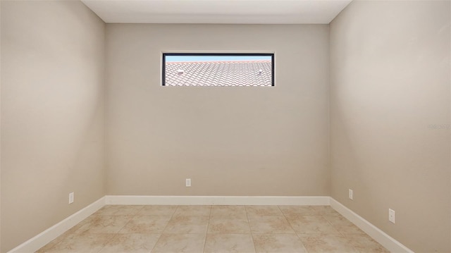 spare room featuring baseboards