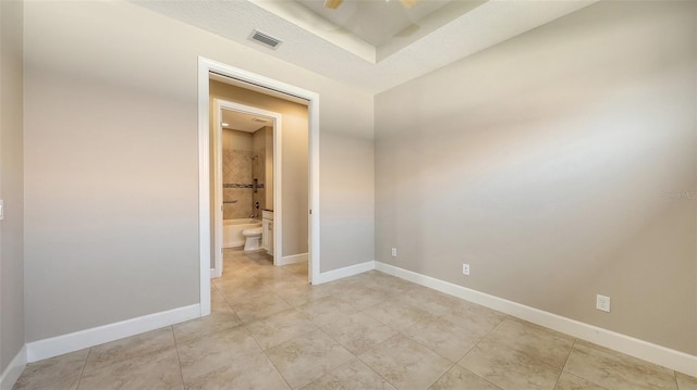 spare room with baseboards, light tile patterned floors, and a ceiling fan