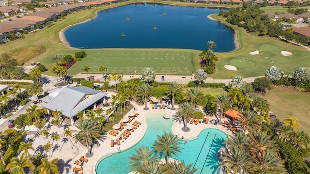 aerial view of property's location featuring a nearby body of water, a pool area, a local golf course, and nearby suburban area
