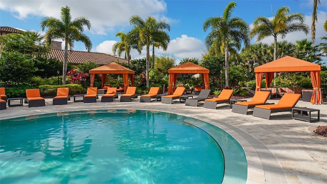 outdoor pool featuring a gazebo and a patio area