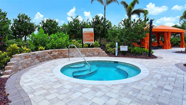view of pool featuring a hot tub and a gazebo