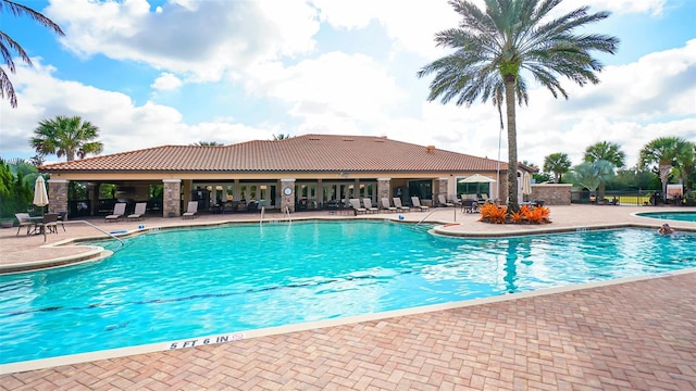 community pool featuring a patio and a jacuzzi