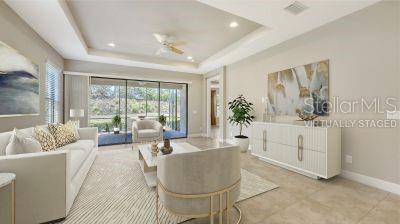 12619 Sorrento Way, Bradenton, FL 34211 - living room featuring baseboards, a raised ceiling, recessed lighting, and a ceiling fan