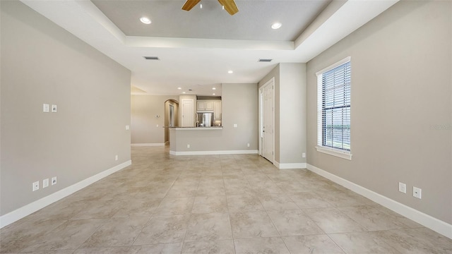 12619 Sorrento Way, Bradenton, FL 34211 - unfurnished living room with a ceiling fan, a raised ceiling, recessed lighting, and baseboards