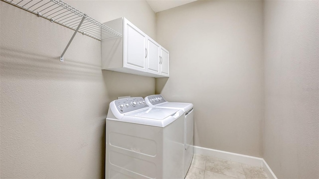 12619 Sorrento Way, Bradenton, FL 34211 - laundry room featuring washer and dryer, baseboards, cabinet space, and light tile patterned flooring